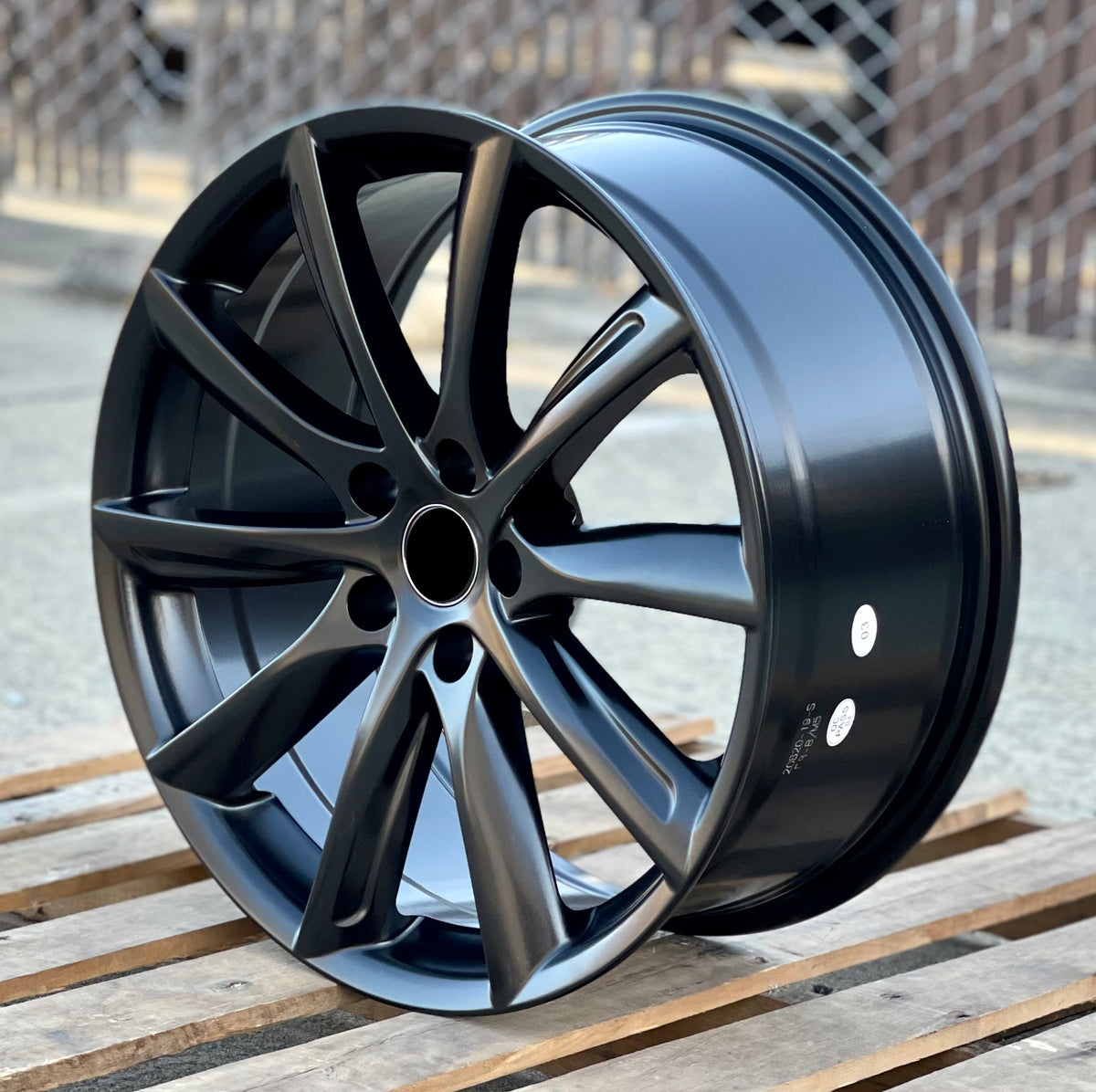 Matte black 19-inch turbine style wheels by OE Style Wheels fitted on a Tesla Model S or X, showing the sleek automotive rim design.