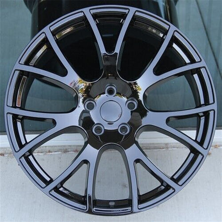 22-inch gloss black mesh style OE Style Wheels on Dodge Durango and Jeep Grand Cherokee, showing sleek automotive rims.