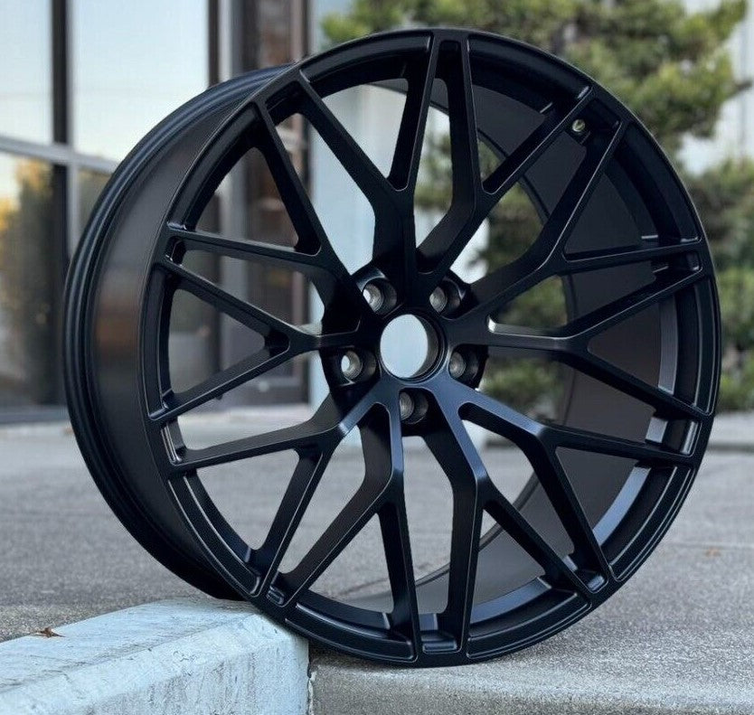 Matte black 21-inch RS Spyder style wheels by OE Style Wheels on a Porsche Macan, showcasing the sleek, sporty design.