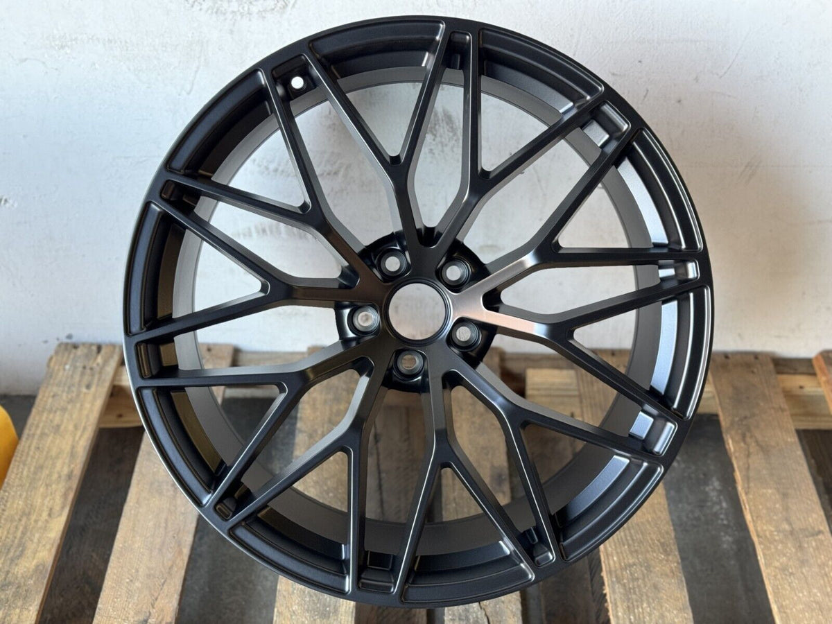 Matte black 21-inch RS Spyder style wheels by OE Style Wheels on a Porsche Macan, showcasing sleek design and fitment.
