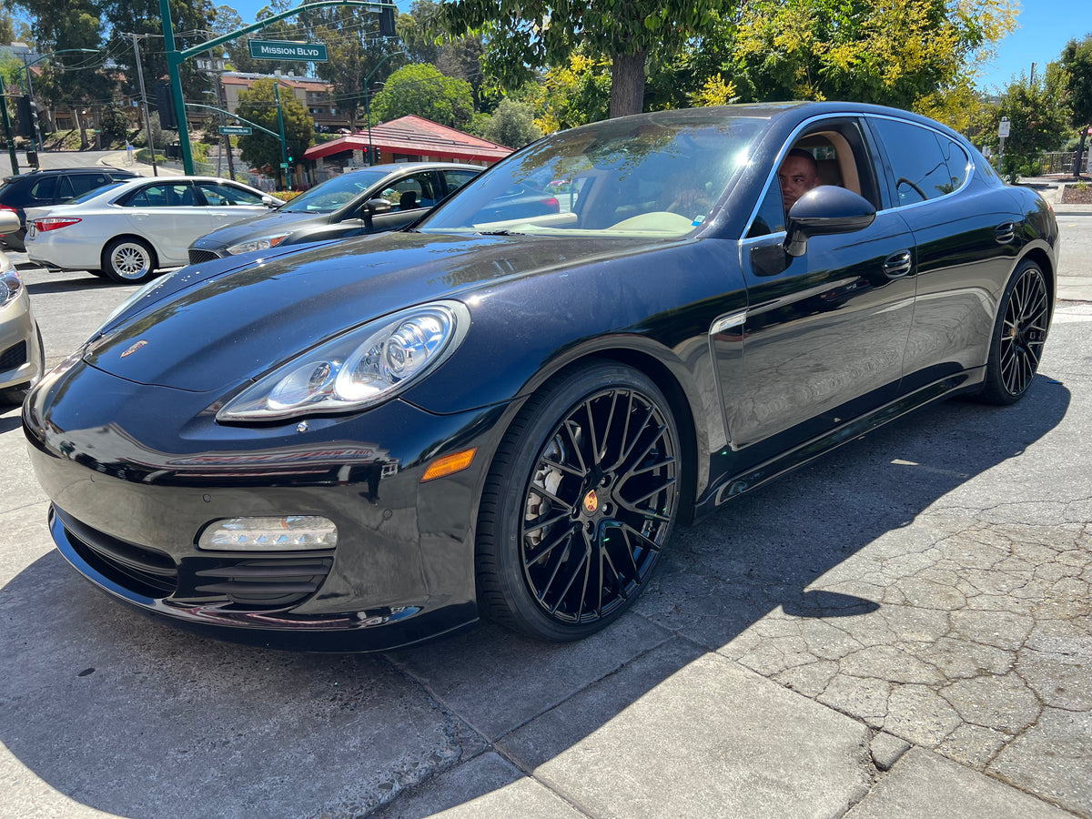 OE Style Wheels 22-inch staggered gloss black GTS coupe style wheels on a Porsche Cayenne GTS hybrid with visible multi-spoke design.