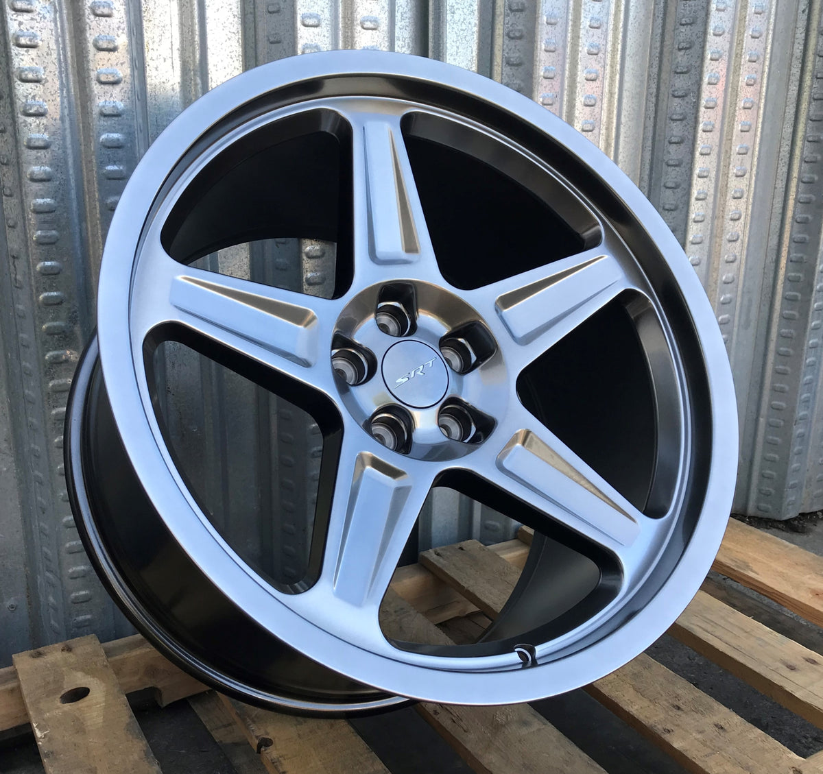 20-inch Demon Style Hyper Black Wheels by OE Style Wheels on a Dodge Challenger and Charger sports car with aggressive design.